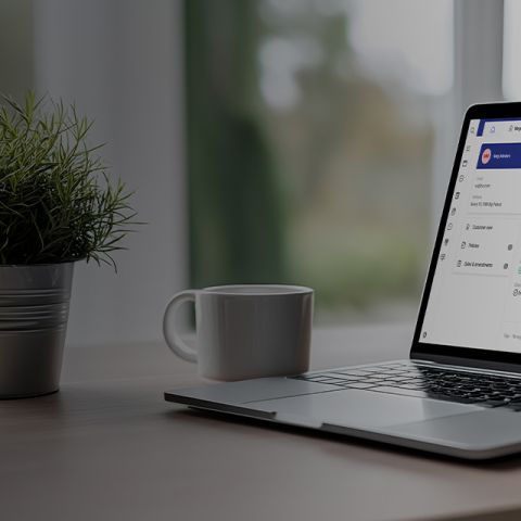 User looking at laptop screen displaying insurance policy details and financial information in a bri