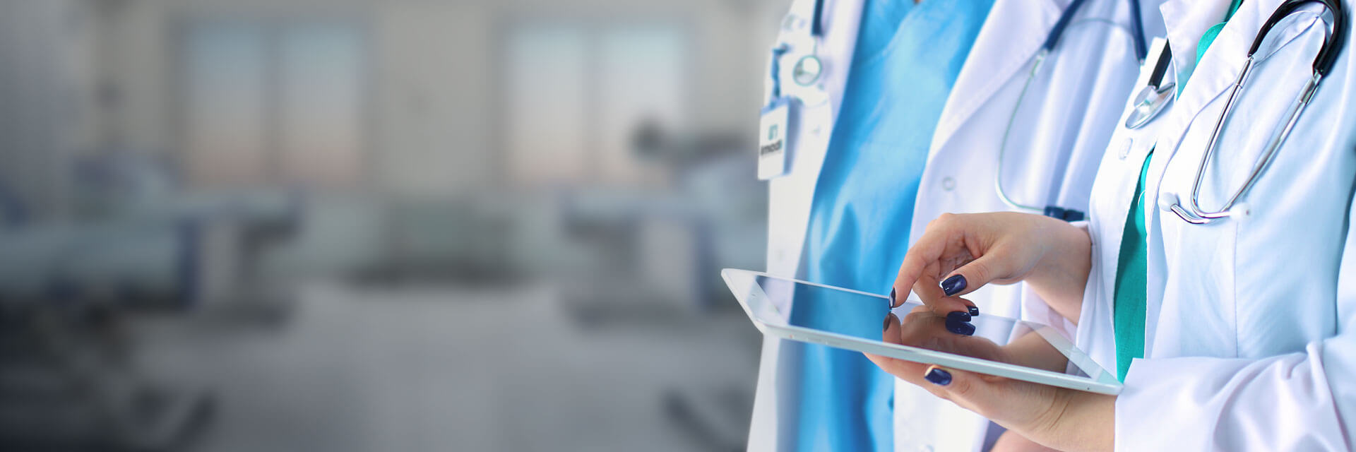 Medical professional using tablet in a healthcare setting with soft lighting and medical equipment i